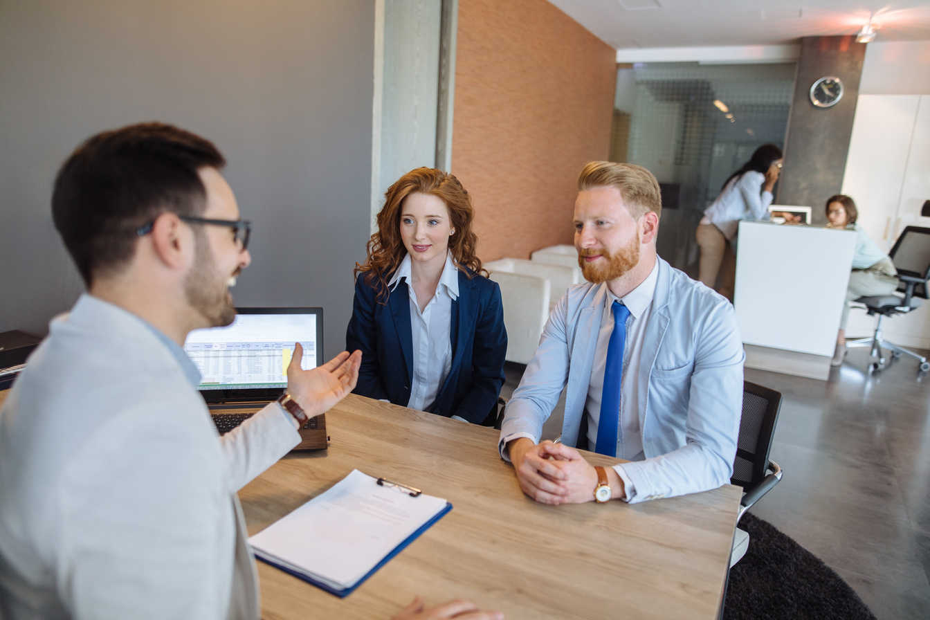 Young couple talking to loan officer